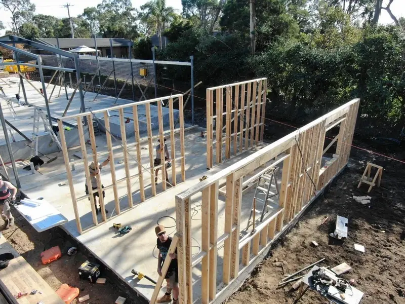 Elevated view of timber wall frames during a home build