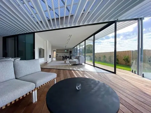 Covered outdoor lounge with timber decking and sliding glass panels