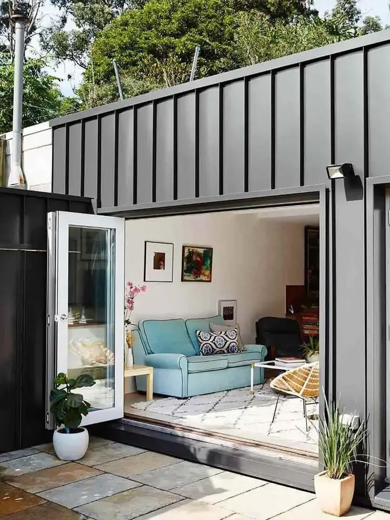 Foxes Hollow Residence — open glass doors connecting an interior room with an outdoor terrace